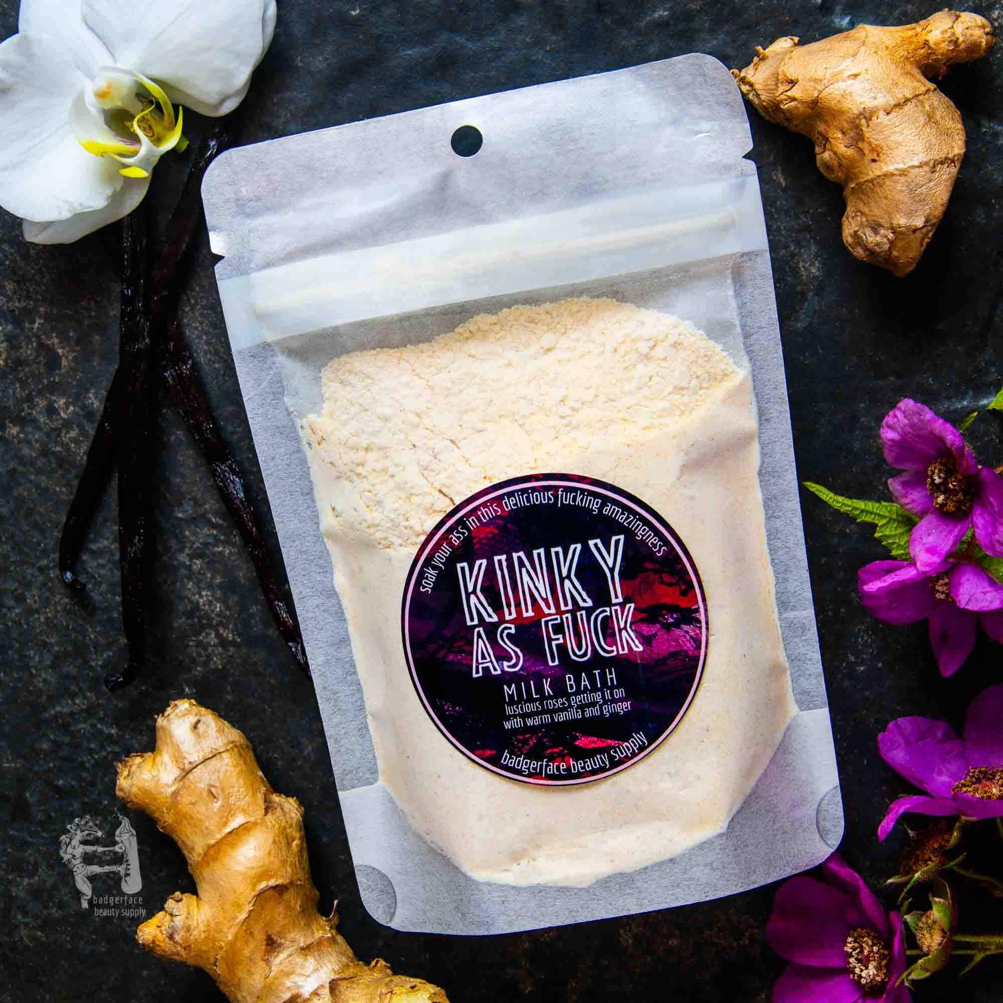 Christmas Gift Box for Women - Plasticology milk bath labeled 'Kinky As Fuck' with ginger, vanilla, and orchid flowers on a dark background