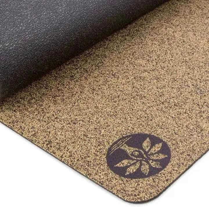 Close-up of Unity Yoga Mat's cork texture and logo, showcasing eco-friendly materials and superior grip for dry or sweaty conditions.